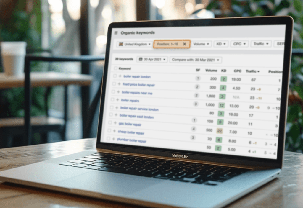 Laptop showing keyword ranking data on screen.